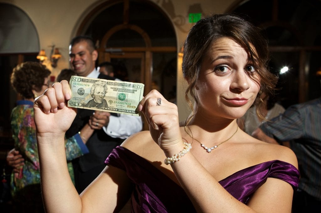 Girl holding twenty dollar bill, Tulsa wedding on a budget