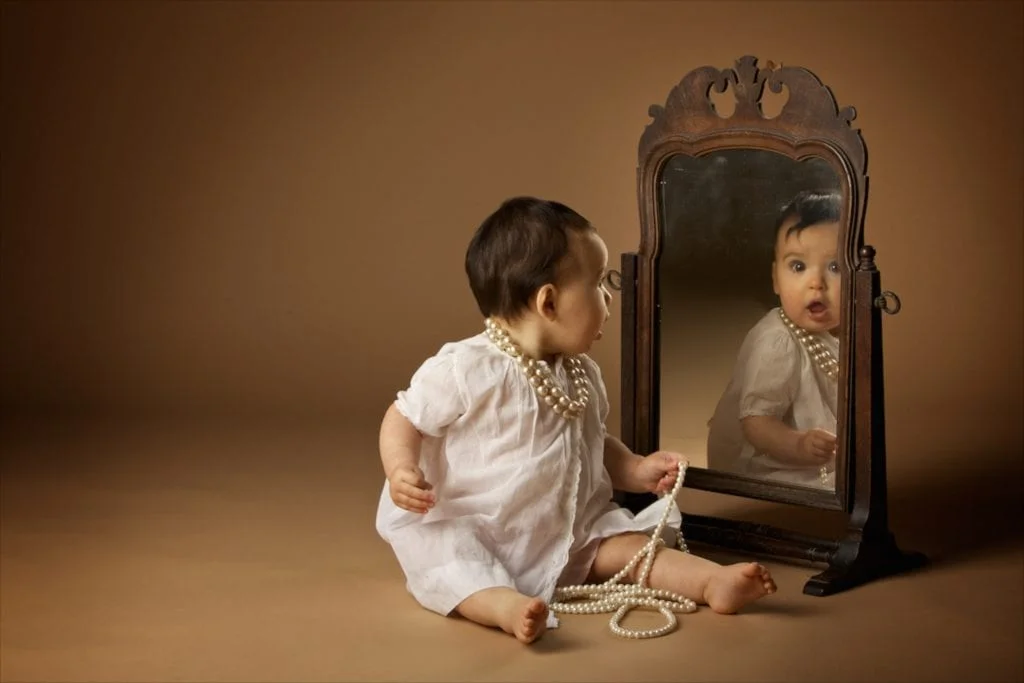 baby looking in mirror