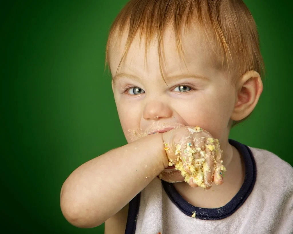 baby eating cake