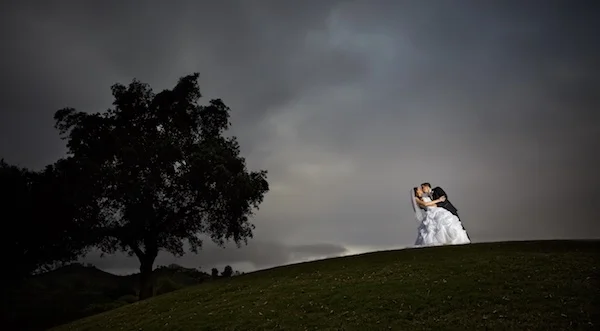 photo of bride and groom on hill