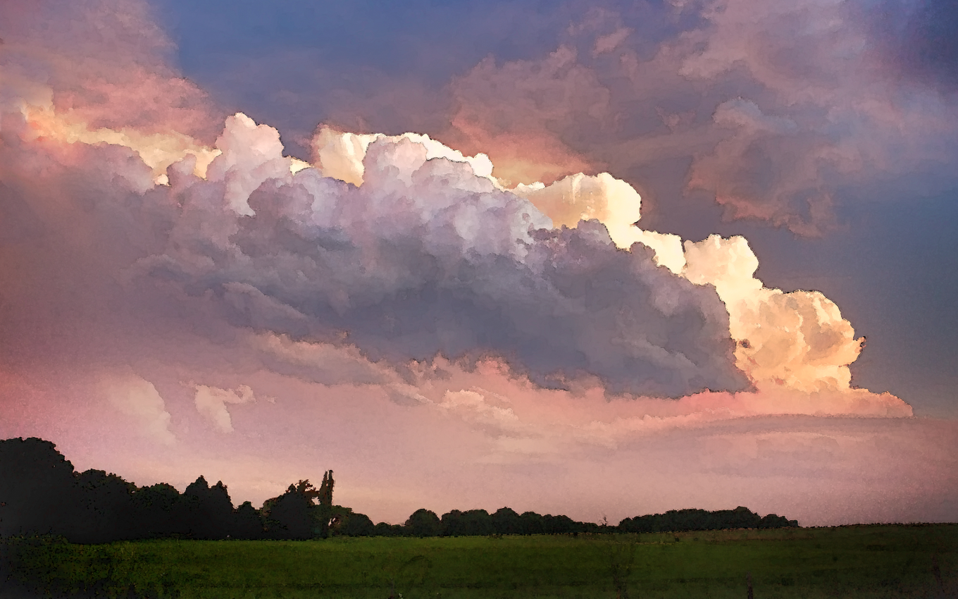 Oklahoma field with a low treeline in the distance and large billowing clouds, possible storm clouds. The photograph has been edited to have a painterly feel.