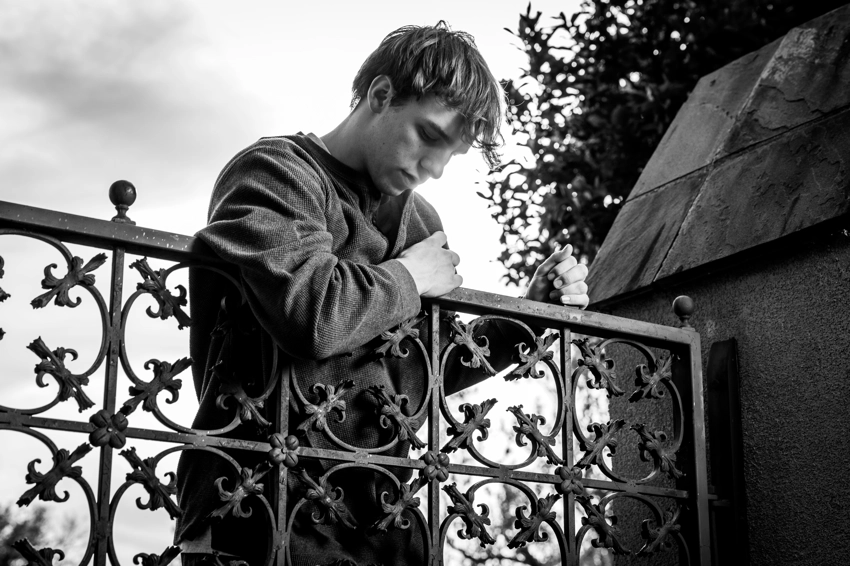 teen with wrought iron gate