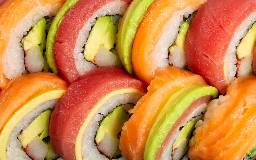 Close up photo of rainbow roll sushi