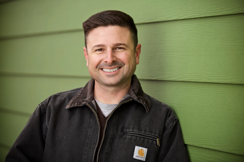 Ben Croff head shot in front of green wall