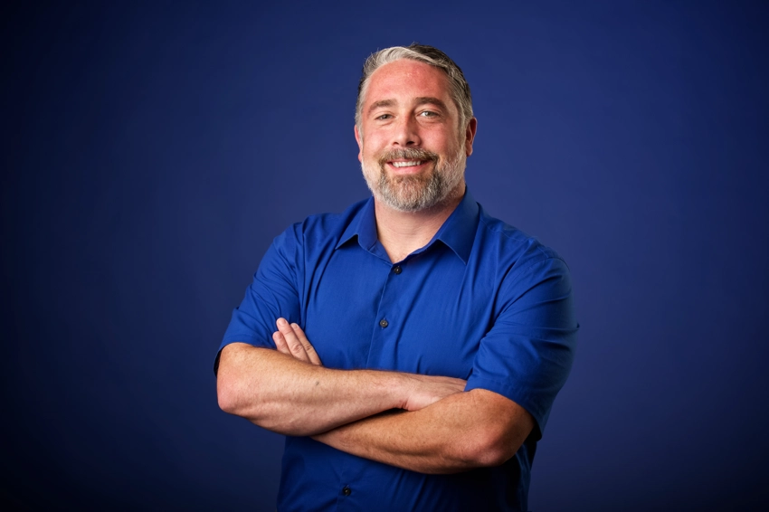 Head shot in Tulsa OK man in blue shirt against blue background