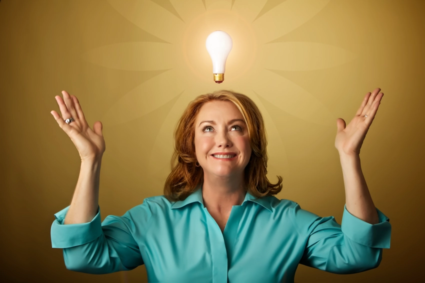 Marketing photo of woman with illuminated light bulb floating over her head