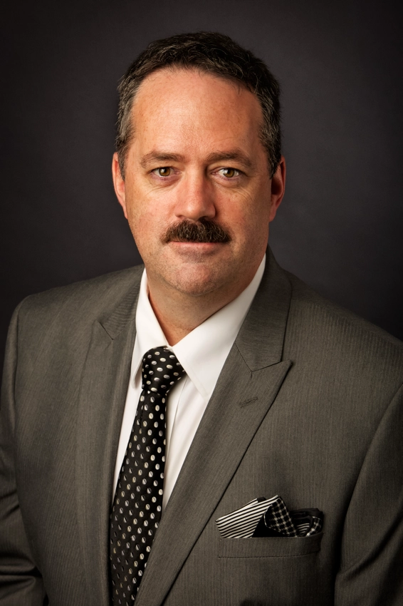 Portrait of Tim Heitman in a suit