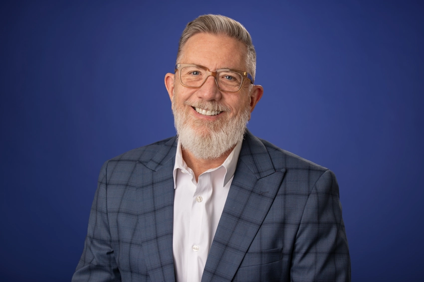Studio portrait on man with glasses in blue checkered sport coat