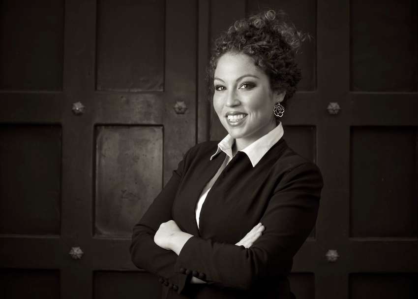 black and white professional head shot of realtor in front of large industrial door