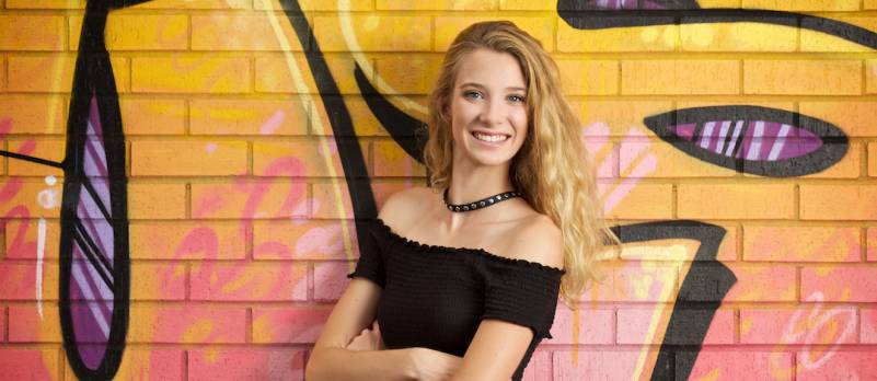 Girl against graffiti wall